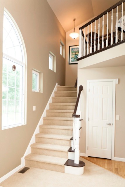 Inspiration for a mid-sized transitional carpeted l-shaped staircase remodel in Charlotte with carpeted risers