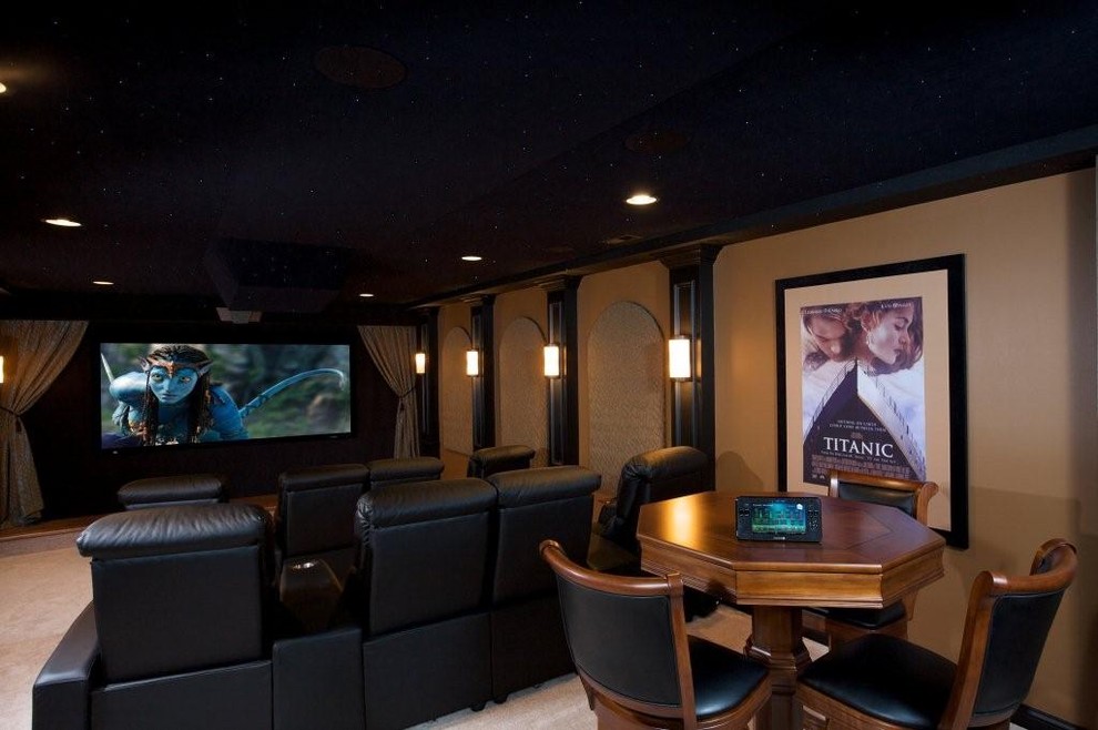 Large traditional enclosed home theatre in Indianapolis with beige walls, carpet and a projector screen.