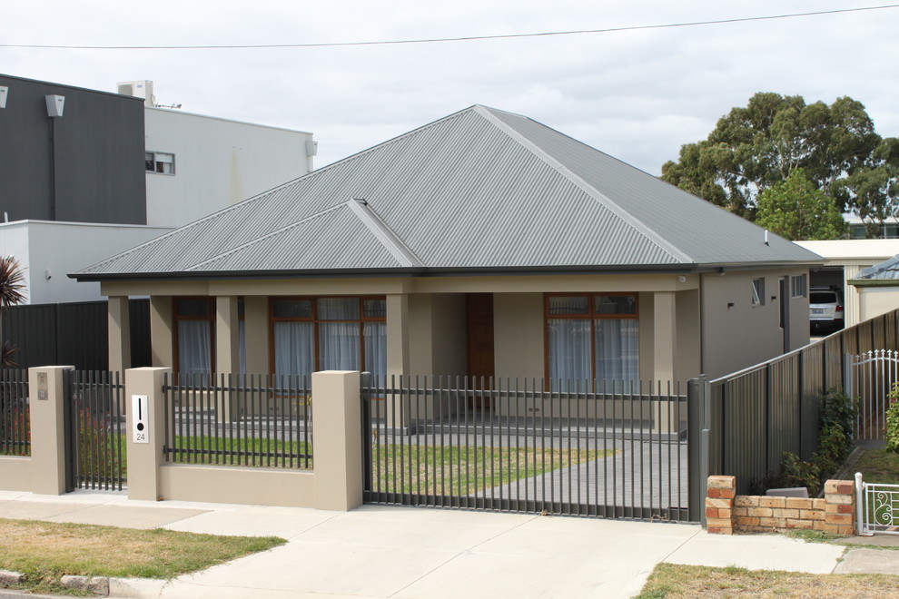 This is an example of a traditional one-storey beige exterior in Adelaide with a hip roof.