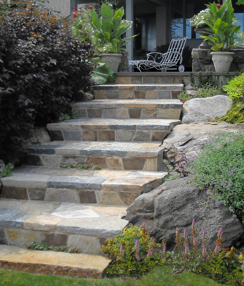Design ideas for a mid-sized rustic full sun hillside stone formal garden in Providence for summer.