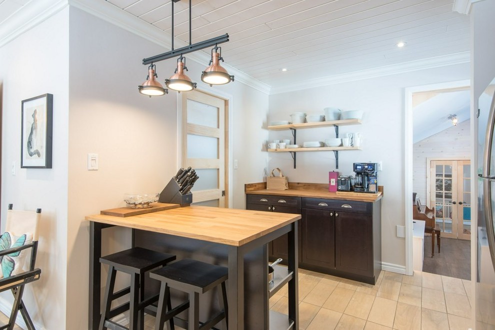 Inspiration for a mid-sized rustic l-shaped ceramic tile and beige floor kitchen remodel with a double-bowl sink, flat-panel cabinets, dark wood cabinets, wood countertops, white backsplash, wood backsplash, stainless steel appliances and an island