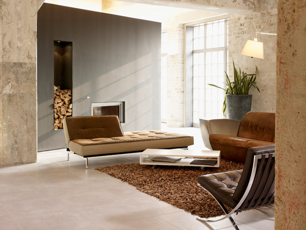Inspiration for a large industrial formal open concept living room in Leipzig with beige walls, a standard fireplace, a metal fireplace surround and beige floor.