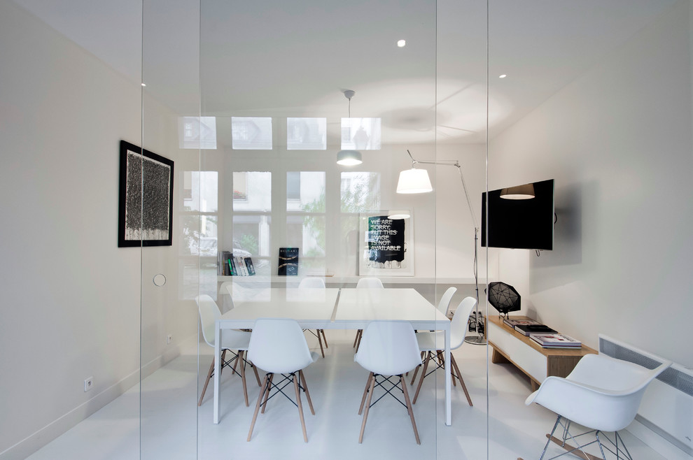 This is an example of a large contemporary separate dining room in Paris with white walls.