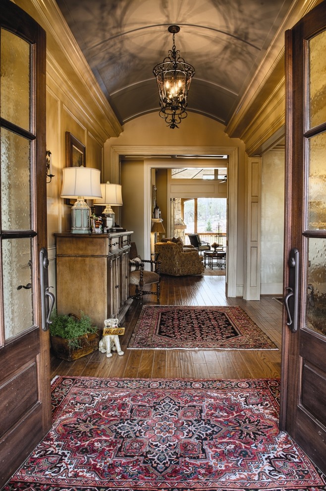 Traditional entryway in Other with beige walls, dark hardwood floors and a double front door.