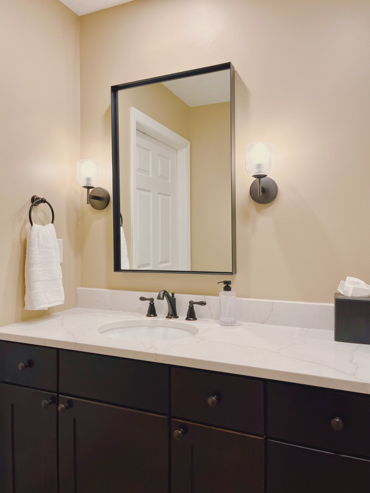 Example of a mid-sized transitional master ceramic tile porcelain tile, beige floor and double-sink alcove shower design with shaker cabinets, dark wood cabinets, a two-piece toilet, beige walls, an undermount sink, quartz countertops, beige countertops and a built-in vanity
