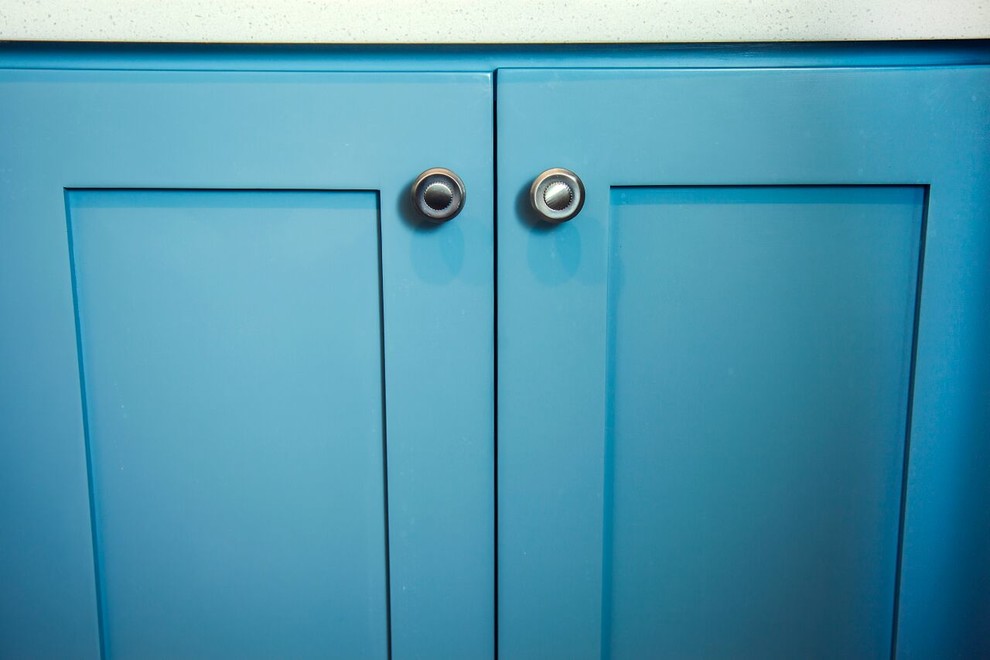 Bathroom - mid-sized master medium tone wood floor bathroom idea in Orlando with blue cabinets, white walls, shaker cabinets, a two-piece toilet, an undermount sink and solid surface countertops