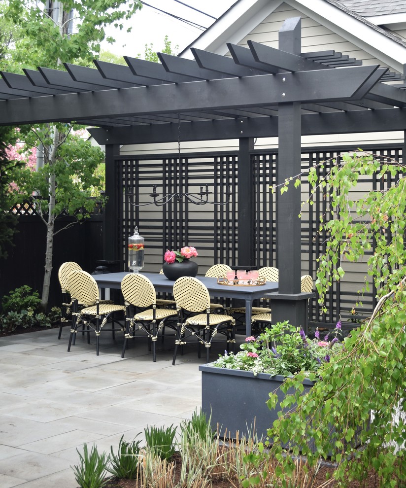 Mid-sized contemporary backyard patio in Chicago with a fire feature, natural stone pavers and a pergola.