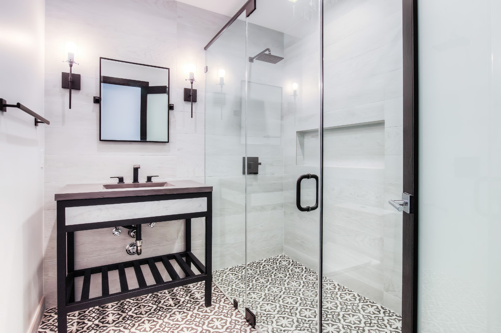 This is an example of a mid-sized modern 3/4 bathroom in Los Angeles with open cabinets, white tile, porcelain tile, an integrated sink, a hinged shower door, black cabinets, a curbless shower, white walls, cement tiles, concrete benchtops, multi-coloured floor and grey benchtops.