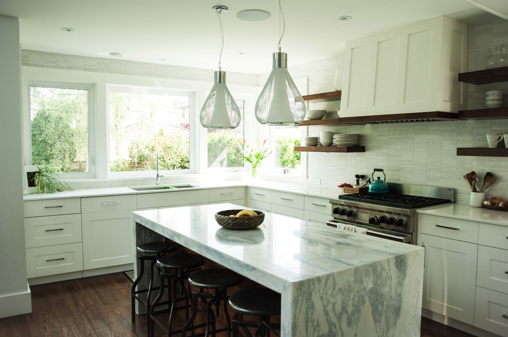 Transitional open plan kitchen in Vancouver with shaker cabinets, white cabinets, marble benchtops, white splashback, stone tile splashback, dark hardwood floors and with island.