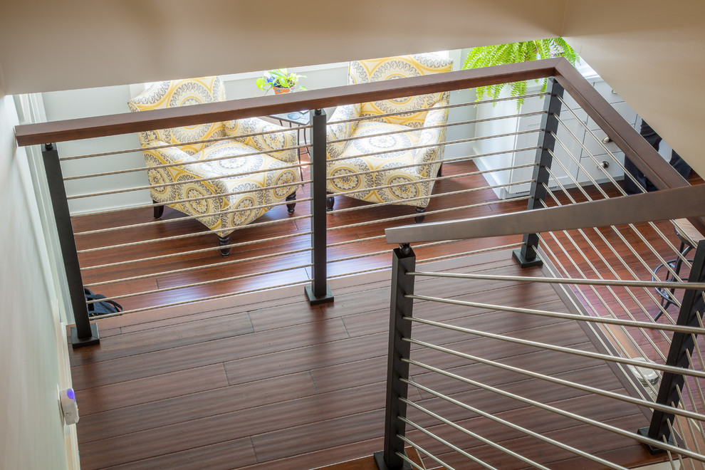 This is an example of a mid-sized contemporary straight staircase in Other with metal railing.
