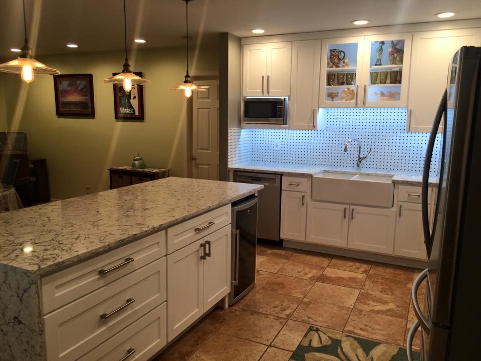 Example of a mid-sized transitional u-shaped ceramic tile and beige floor open concept kitchen design in Austin with a farmhouse sink, shaker cabinets, white cabinets, granite countertops, multicolored backsplash, porcelain backsplash, stainless steel appliances and an island