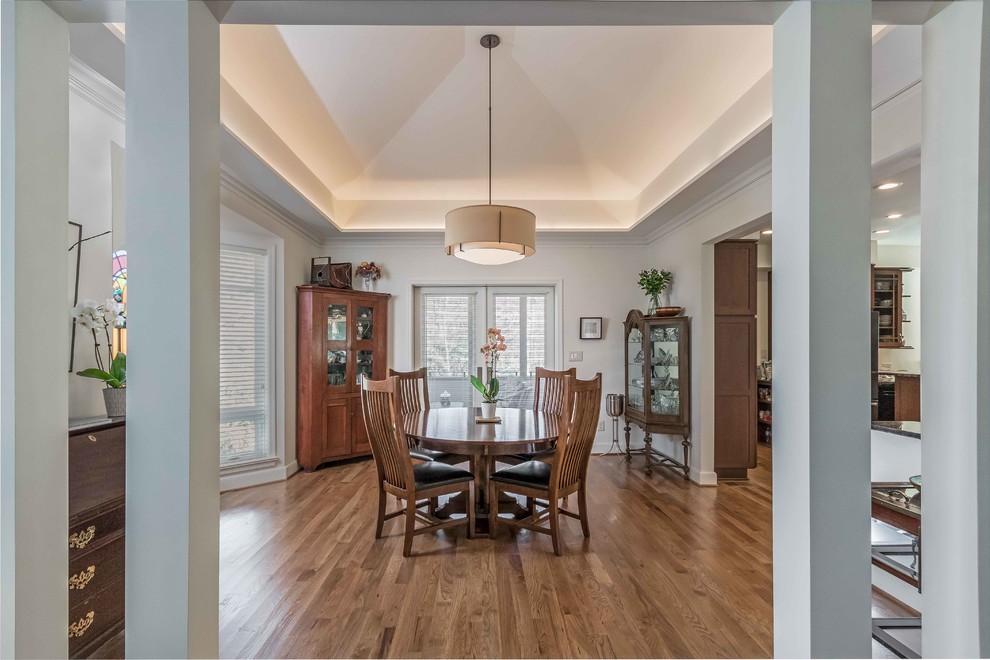 Photo of a mid-sized traditional separate dining room in Raleigh with beige walls, no fireplace, brown floor and dark hardwood floors.