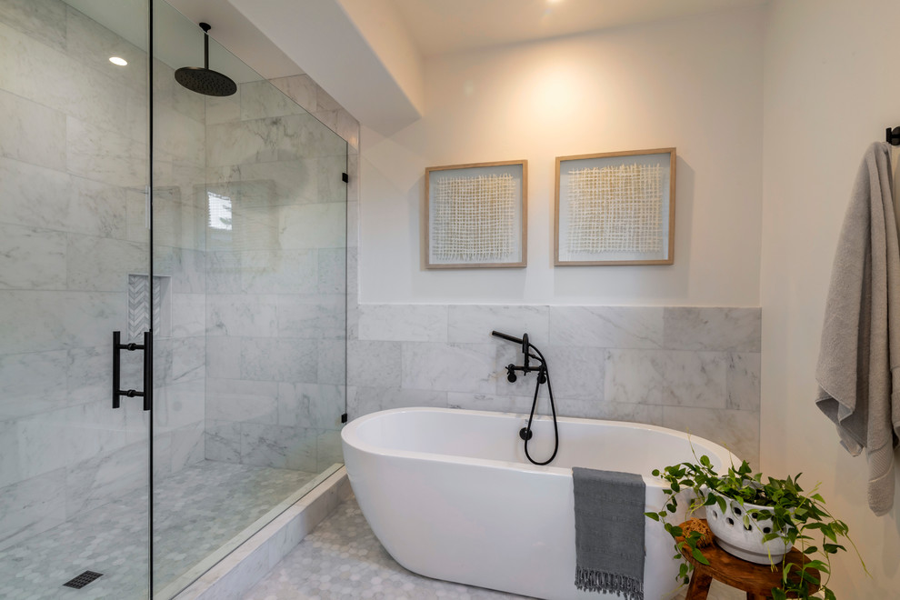 Large contemporary master bathroom in Santa Barbara with shaker cabinets, light wood cabinets, a freestanding tub, a double shower, a one-piece toilet, gray tile, marble, white walls, marble floors, an undermount sink, engineered quartz benchtops, grey floor, a hinged shower door and white benchtops.