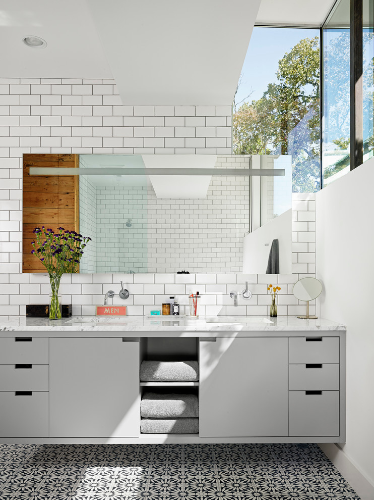 Inspiration for a contemporary bathroom in Austin with an undermount sink, flat-panel cabinets, grey cabinets, white tile and subway tile.