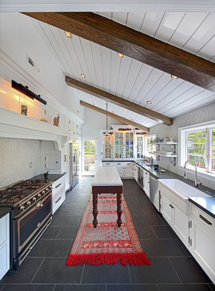 Traditional kitchen in Los Angeles with a farmhouse sink, slate floors and black floor.