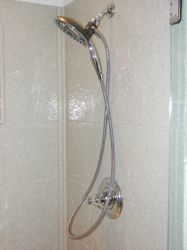 Mid-sized transitional 3/4 white tile and subway tile corner shower photo with shaker cabinets, white cabinets, a two-piece toilet, blue walls, an undermount sink and quartz countertops
