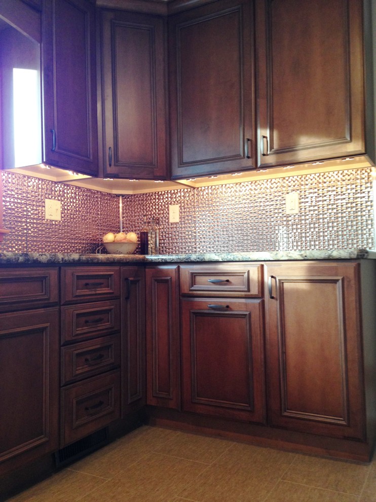 Eat-in kitchen - small transitional u-shaped eat-in kitchen idea with an undermount sink, flat-panel cabinets, medium tone wood cabinets, laminate countertops and a peninsula