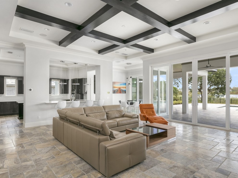 Design ideas for a large modern open concept family room in Orlando with grey walls, travertine floors, a ribbon fireplace, a stone fireplace surround, a wall-mounted tv and grey floor.