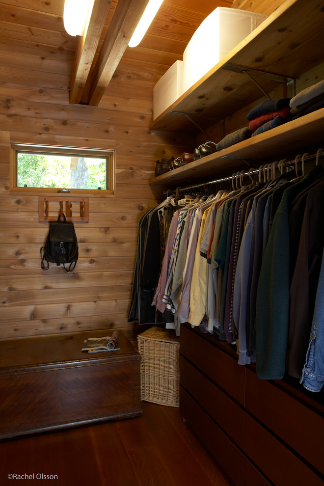 Mid-sized transitional gender-neutral walk-in wardrobe in Seattle with flat-panel cabinets, medium wood cabinets, dark hardwood floors and exposed beam.