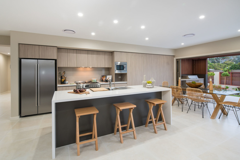 Mid-sized contemporary galley eat-in kitchen in Brisbane with a double-bowl sink, brown cabinets, solid surface benchtops, beige splashback, glass sheet splashback, stainless steel appliances, cement tiles and with island.