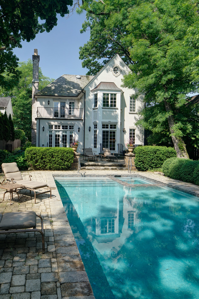This is an example of a traditional pool in Chicago with natural stone pavers.