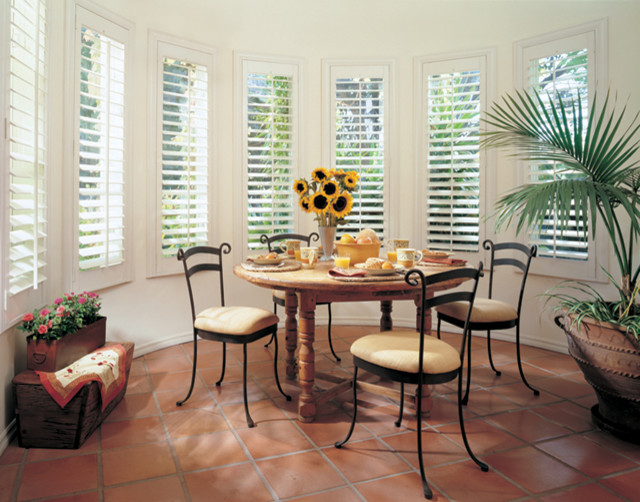 Inspiration for a mid-sized tropical separate dining room in Atlanta with white walls, terra-cotta floors, no fireplace and red floor.