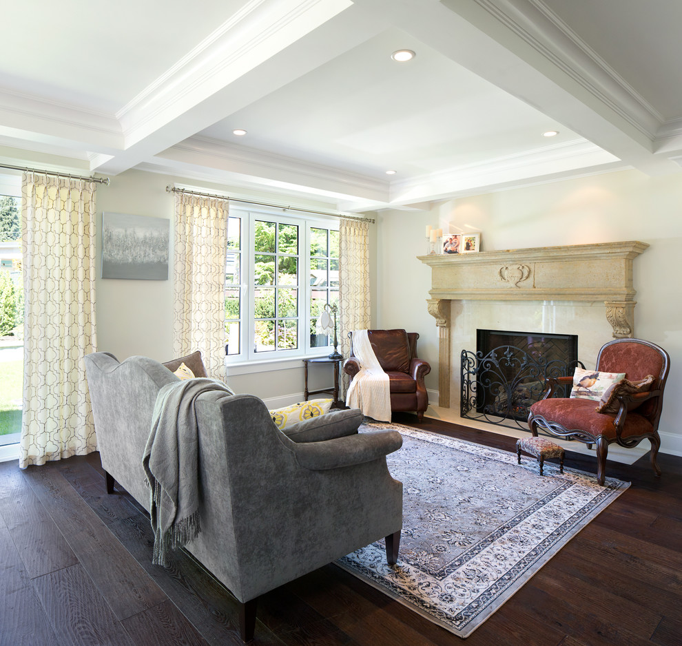 Inspiration for a mid-sized traditional living room in Vancouver with beige walls, dark hardwood floors, a standard fireplace and a stone fireplace surround.