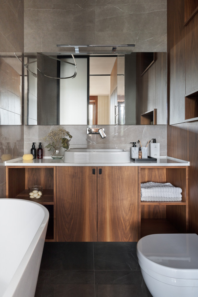 Идея дизайна: главная ванная комната среднего размера: освещение в современном стиле с фасадами цвета дерева среднего тона, отдельно стоящей ванной, белой столешницей, окном, тумбой под одну раковину и подвесной тумбой