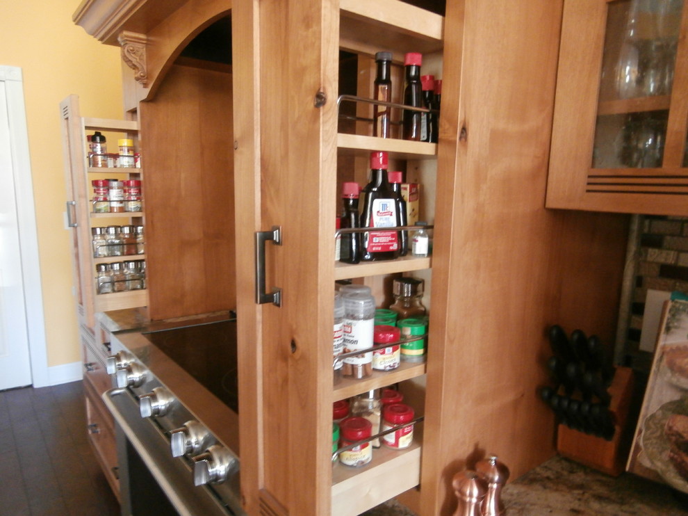 Example of a large mountain style single-wall dark wood floor and brown floor eat-in kitchen design with shaker cabinets, medium tone wood cabinets, laminate countertops, metallic backsplash, stainless steel appliances and two islands