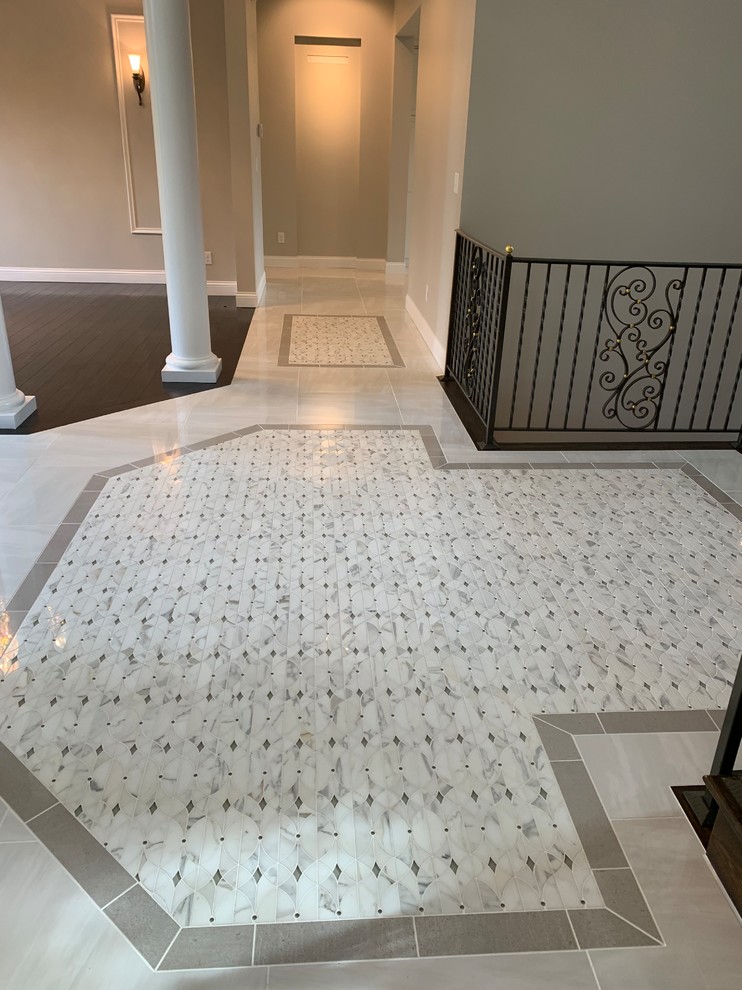 Foyer - huge transitional porcelain tile and white floor foyer idea in Cincinnati with gray walls and a dark wood front door