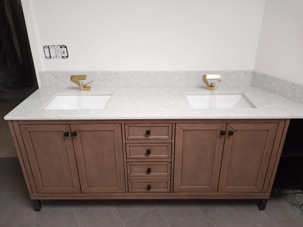 Example of a mid-sized trendy master cement tile floor, gray floor, double-sink and vaulted ceiling bathroom design in Seattle with shaker cabinets, brown cabinets, a two-piece toilet, white walls, an undermount sink, granite countertops, gray countertops and a freestanding vanity