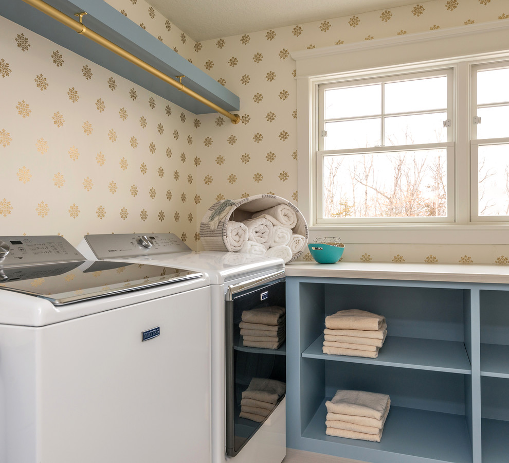 Photo of a traditional laundry room in Minneapolis with open cabinets, blue cabinets, multi-coloured walls, a side-by-side washer and dryer and white benchtop.