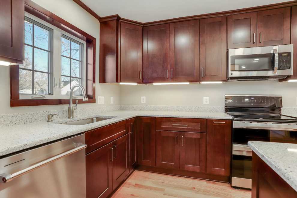 Large traditional l-shaped enclosed kitchen in DC Metro with a submerged sink, shaker cabinets, medium wood cabinets, engineered stone countertops, stainless steel appliances, an island and multicoloured worktops.