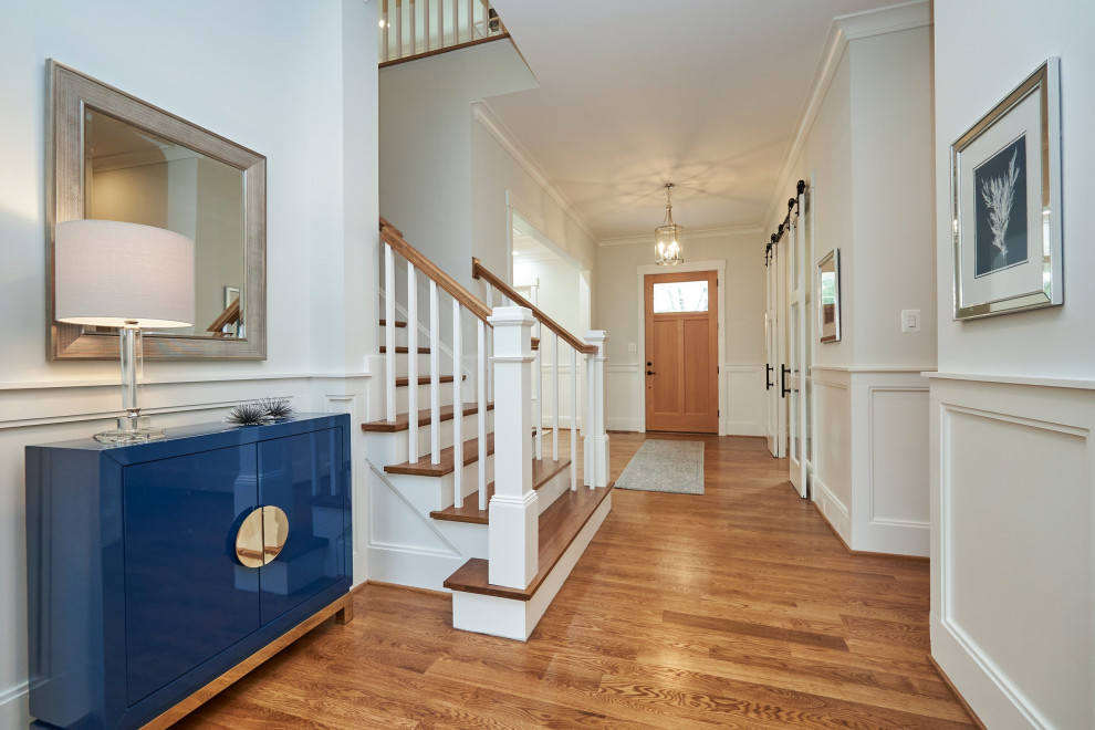 Mid-sized transitional medium tone wood floor and brown floor foyer photo in DC Metro with white walls and a medium wood front door