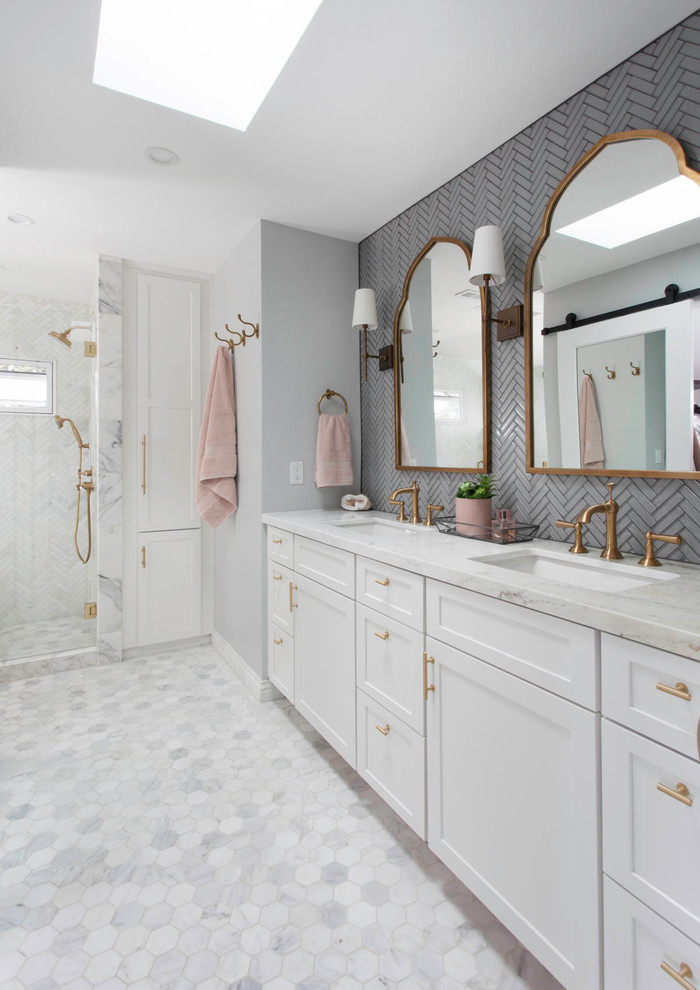 Mid-sized transitional master bathroom in Denver with white cabinets, an alcove shower, gray tile, glass tile, grey walls, marble floors, an undermount sink, marble benchtops, white floor, white benchtops and shaker cabinets.