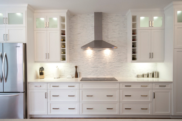 Kitchen - dark wood floor kitchen idea with a double-bowl sink, recessed-panel cabinets, white cabinets, multicolored backsplash, ceramic backsplash, black appliances and an island