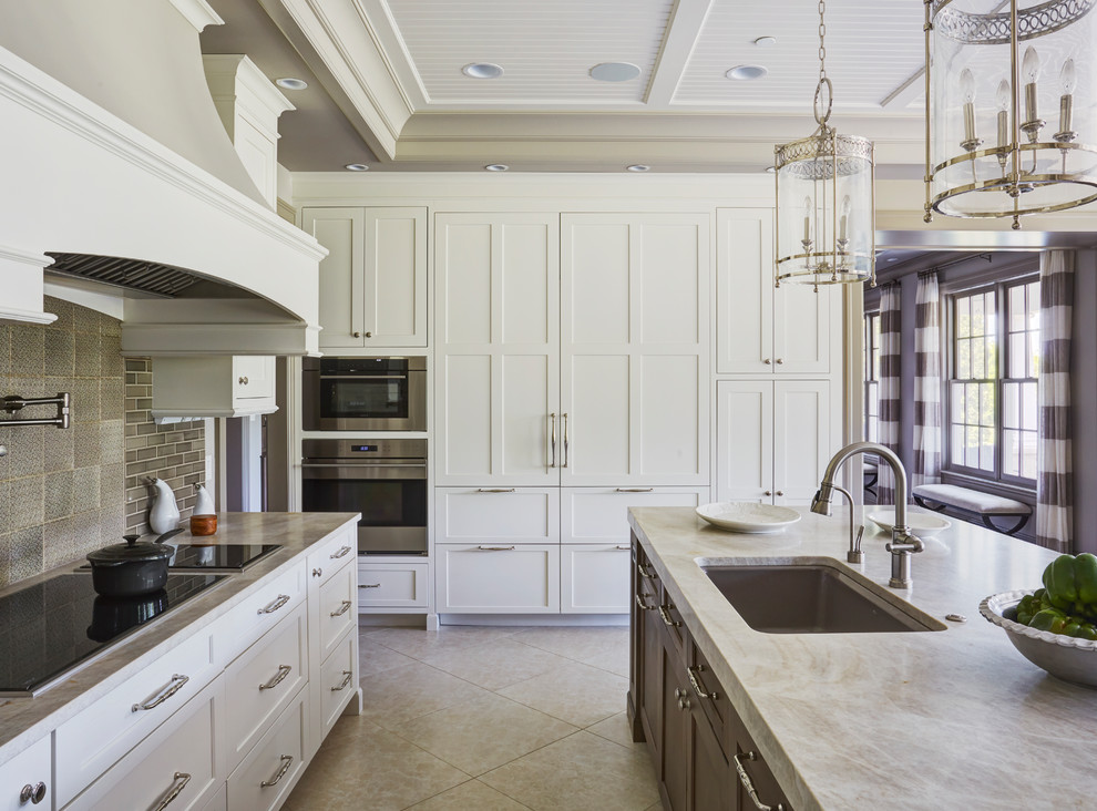 Eat-in kitchen - large transitional u-shaped ceramic tile and gray floor eat-in kitchen idea with a double-bowl sink, raised-panel cabinets, white cabinets, marble countertops, beige backsplash, ceramic backsplash, stainless steel appliances and two islands