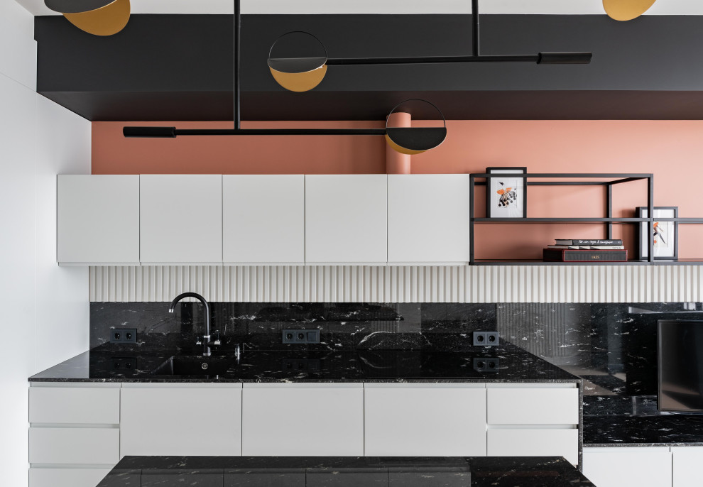 Photo of a small scandinavian single-wall eat-in kitchen in Moscow with an undermount sink, flat-panel cabinets, white cabinets, granite benchtops, black splashback, granite splashback, black appliances, medium hardwood floors, with island, grey floor and black benchtop.
