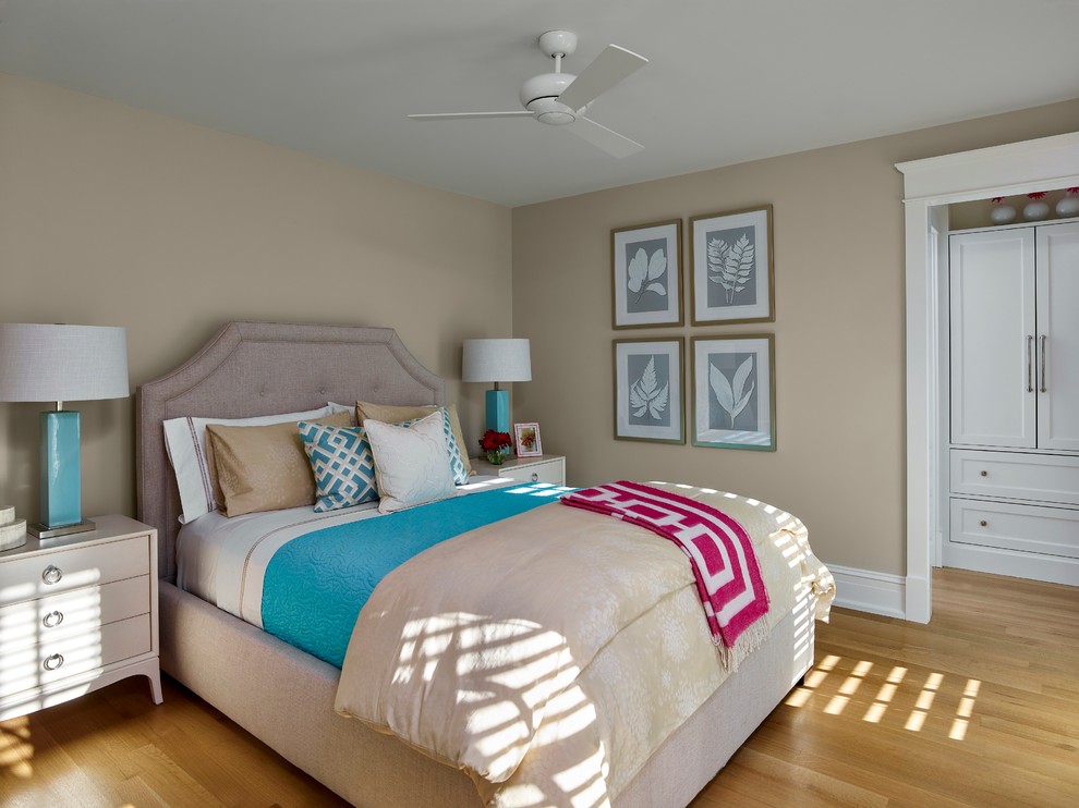 This is an example of a beach style bedroom in Philadelphia with beige walls, medium hardwood floors and no fireplace.