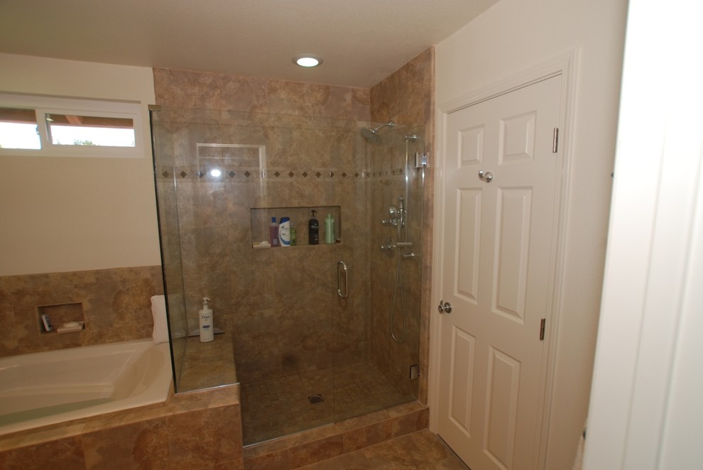 This is an example of a large country master bathroom in Orange County with raised-panel cabinets, light wood cabinets, a hot tub, an open shower, a two-piece toilet, beige tile, porcelain tile, white walls, porcelain floors, an undermount sink, granite benchtops, beige floor, a hinged shower door and beige benchtops.