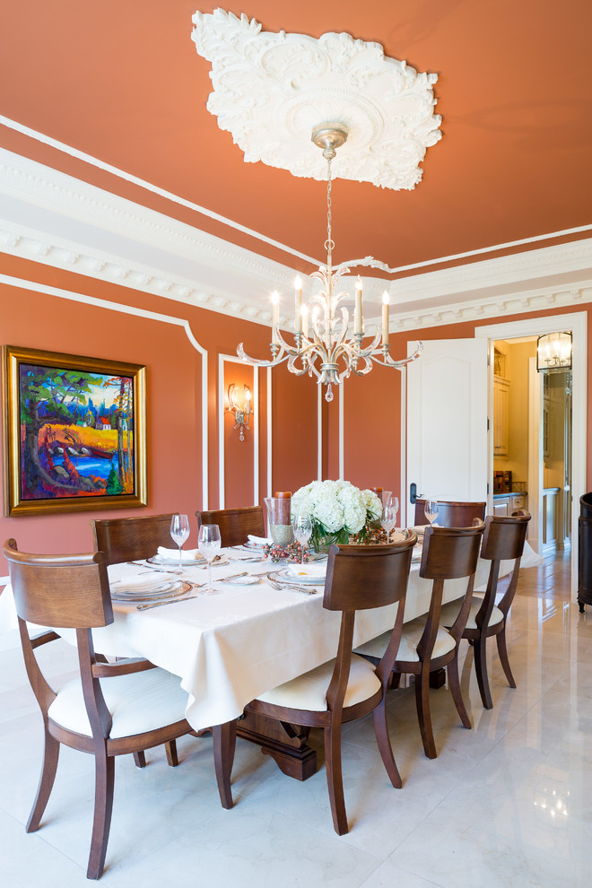 Inspiration for a traditional dining room in Toronto with orange walls.