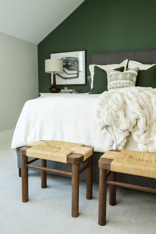 This is an example of a mid-sized transitional guest bedroom in Columbus with green walls and carpet.