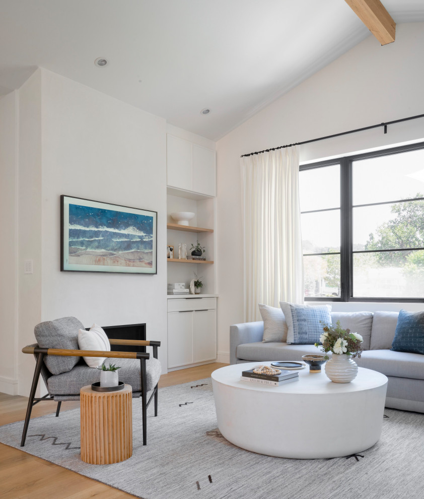 Photo of a medium sized contemporary open plan living room in San Francisco with white walls and light hardwood flooring.