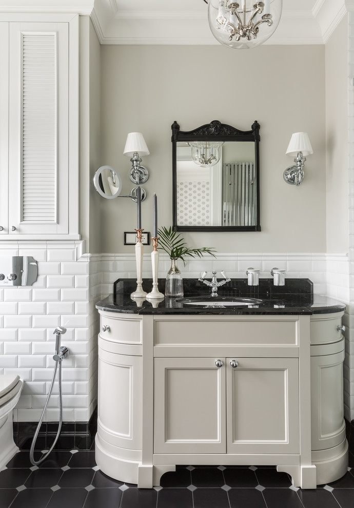 This is an example of a traditional bathroom in Other with beige cabinets, white tile, subway tile, grey walls, an undermount sink, black floor, black benchtops and recessed-panel cabinets.