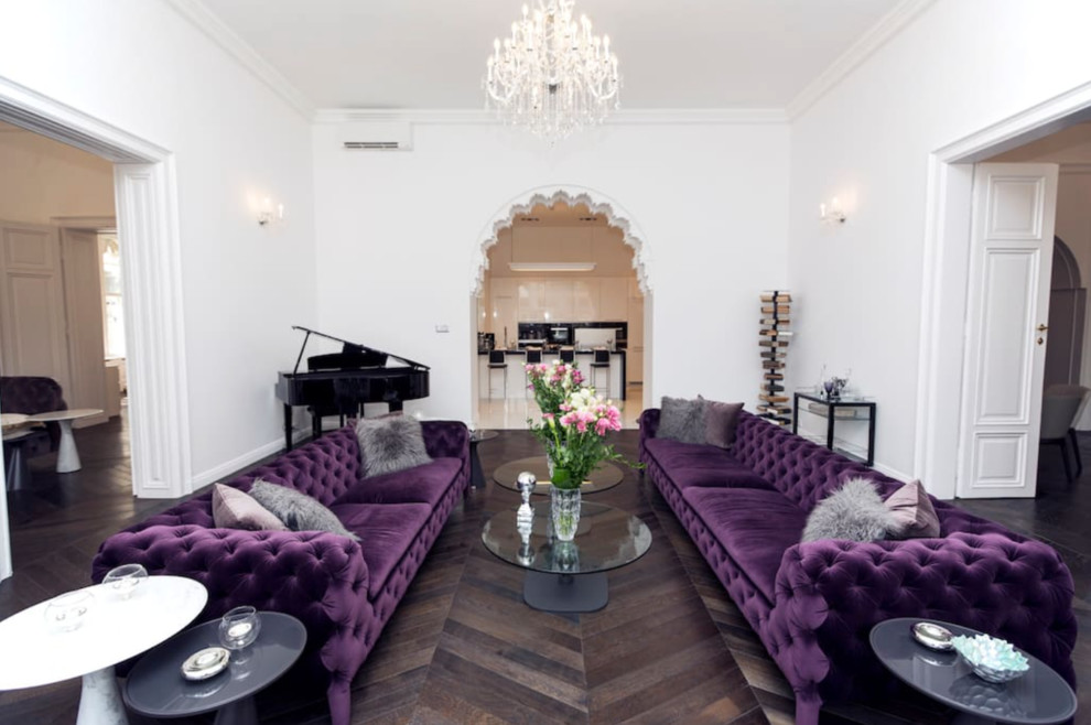 This is an example of a large traditional formal open concept living room in London with white walls and dark hardwood floors.