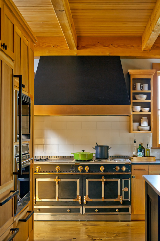 Design ideas for a country kitchen in Burlington with white splashback and black appliances.