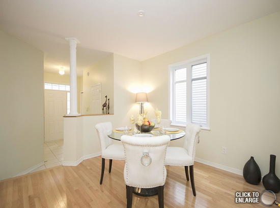 Mid-sized transitional dining room in Ottawa with beige walls and light hardwood floors.