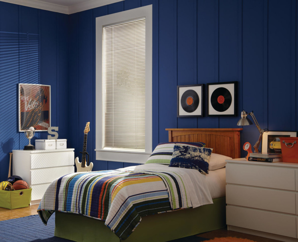 This is an example of a mid-sized eclectic gender-neutral kids' room in Albuquerque with blue walls, light hardwood floors, brown floor and panelled walls.