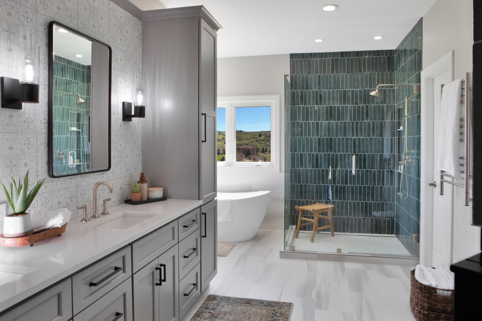 Design ideas for a large transitional master bathroom in Denver with recessed-panel cabinets, grey cabinets, a freestanding tub, an open shower, a one-piece toilet, green tile, cement tile, white walls, porcelain floors, an undermount sink, engineered quartz benchtops, white floor, a hinged shower door, white benchtops, a niche, a double vanity and a built-in vanity.