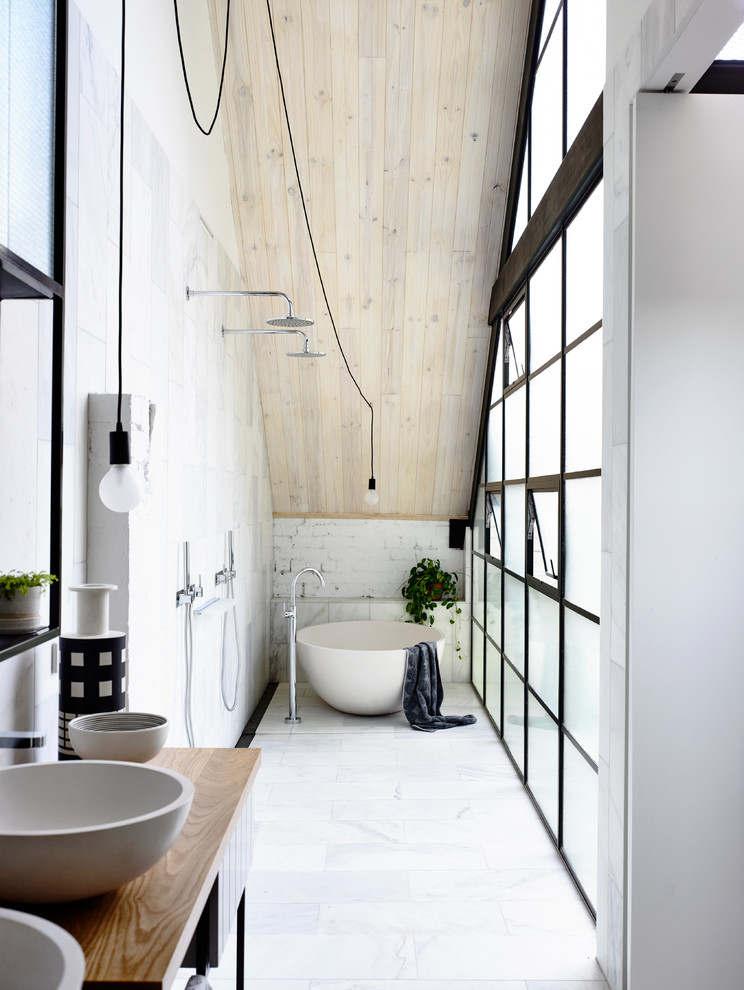 Design ideas for an industrial master bathroom in Melbourne with a freestanding tub, an open shower, white walls, a vessel sink, wood benchtops, white floor, an open shower and brown benchtops.
